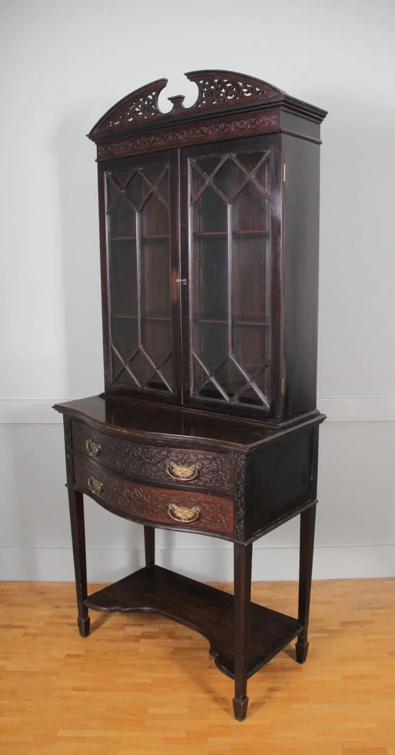 Victoriaans cabinet in Chippendale stijl - Meubel › Kasten - €750.00 - Klein tweeledig cabinet met een lowboy en opzetvitrine. Mahoniehout gedonkerd. Druk vlak snijwerk in laden en op kap (zgn Chippendale stijl). Originele trekkers in gedreven messing.
76cm breed, maximaal 45cm diep, 180cm hoog.

Victoriaans tijdperk, ca 1870/1880