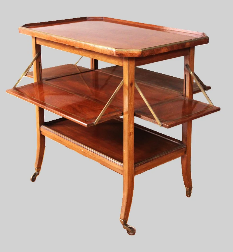 Vintage trolley  - Meubel › Bijzetmeubels - €365.00 - Dientafel in mahonie met messing filets ingelegd.
Neerklapbare zijkanten aan het middenblad.
Originele wieltjes.
76 x 48cm in gesloten toestand; 72cm hoog
ca 1960/1970
